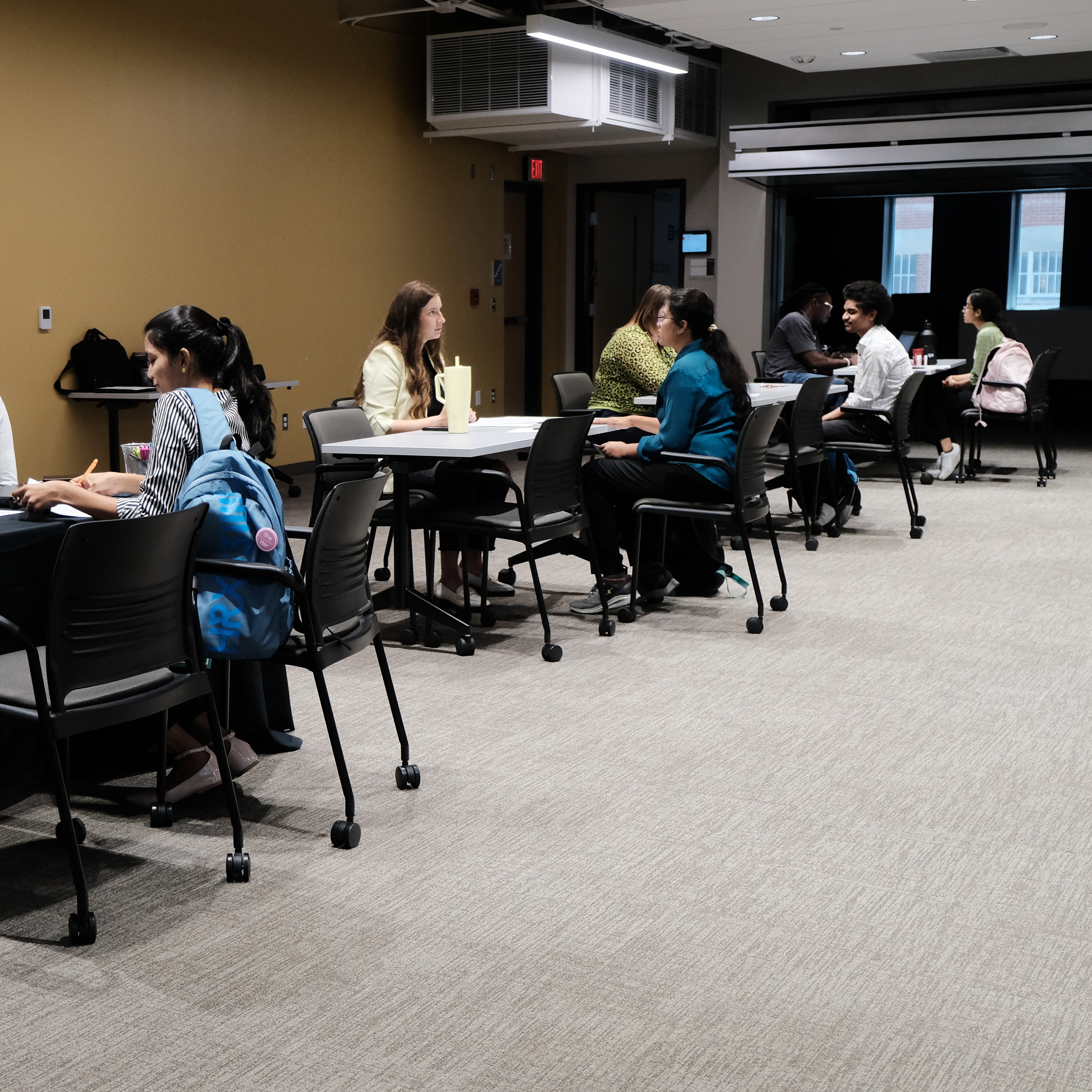 Professional meeting with students and employers discussing opportunities